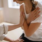 Woman receiving chiropractic therapy with a specialist in an indoor setting.